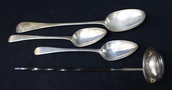 A Victorian silver basting spoon, two George III silver table spoons and a toddy ladle.